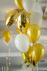 Yellow air balloons and helium gold stars fly