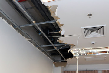 Ceiling panels damaged hole in the roof of house from drain pipes water leakage. House problem from...