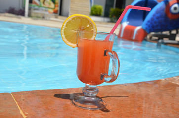 Two Colorful Tropical Cocktails near the Swimming Pool on the Background of Warm Blue Sea. Exotic Summer Vacation.