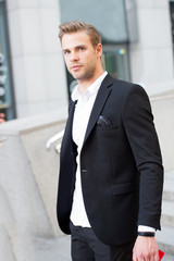 Man formal outfit businessman handsome well groomed urban background. Gentleman dressed professional attire mean serious business. High level respect comes with outfit. Outfit mean focus sharp