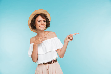 Portrait of a smiling young woman in summer hat