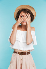 Portrait of a smiling young woman in summer hat