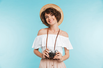 Portrait of a smiling young woman in summer hat
