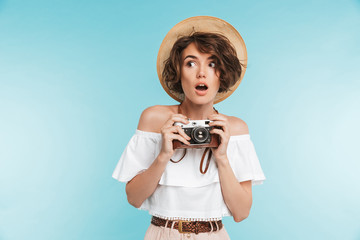 Portrait of a scared young woman in summer hat