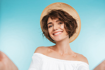 Portrait of a smiling young woman taking a selfie