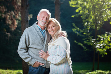 Happy senior couple smiling outdoors in nature 