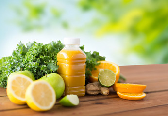 healthy eating, food, dieting and vegetarian concept - bottle with orange juice, fruits and...