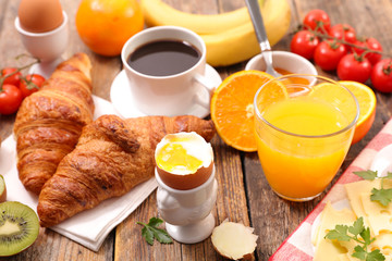 breakfast with coffee, egg, croissant and fruit