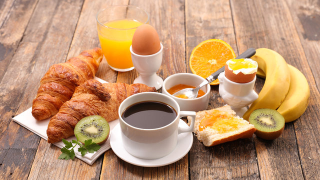 breakfast with coffee, egg, croissant and fruit