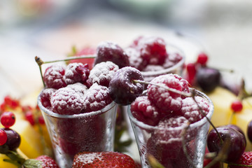 Raspberry in a glass of wine sprinkled with powdered sugar