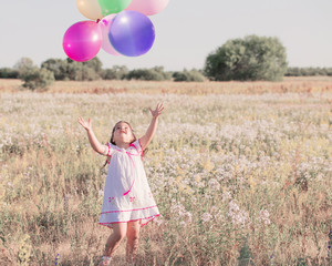little girl with balloons outdoor