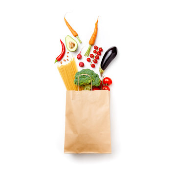 Photo of paper bag with vegetables and spaghetti