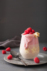healthy layered raspberry banana smoothie in glass