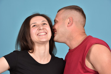 Obraz premium Young family on a blue background. Perfect pair. A good relationship. Strong friendship.
