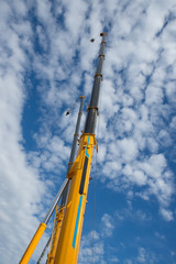 Fototapeta na wymiar Elements of large mobile construction cranes tower on sky background