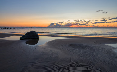 Beach sunset is a golden sky with  waves