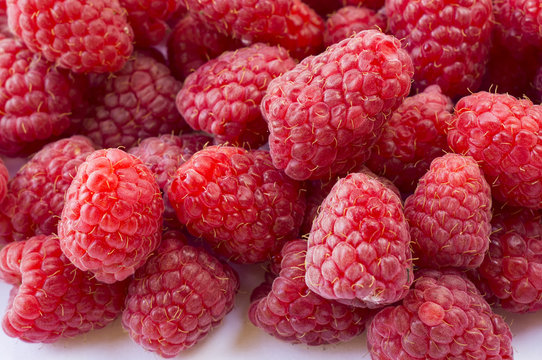 Background of raspberries. Fresh raspberries closeup. Top view. Background of red berries. Various fresh summer fruits.