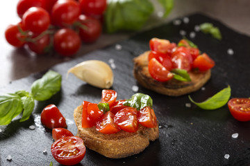 Italian antipasto called Bruschetta topped with tomatoes, garlic and basil