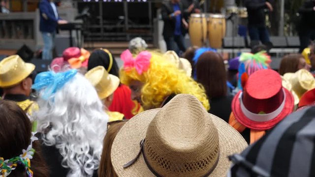 Festival people crowd in carnival costumes hang out cheer and dance at free street concert