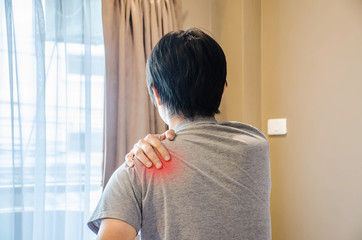 Man waking up in the morning and suffering From Shoulder Pain