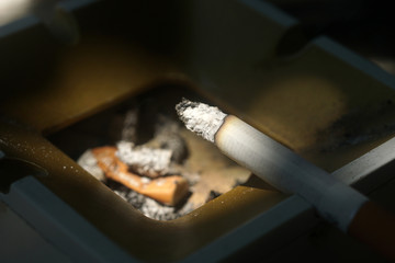 Cigarette on a dirty ashtray