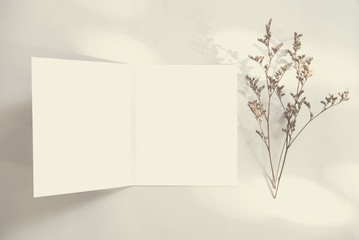 Blank white greeting card with envelope and flower. for mockup template. vintage tone.