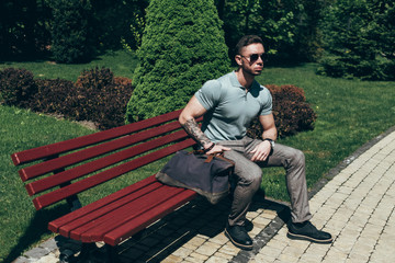 Young Guy with Beard and with Glasses in Stylish Outfit Posing on the Street