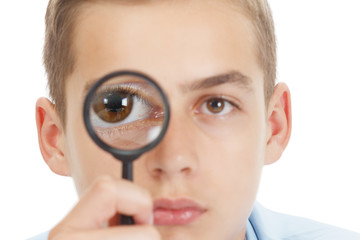 Funny Child with a magnifying glass at School.