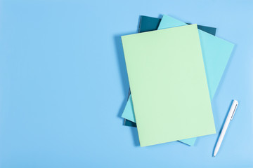 Colorful notebooks on blue background