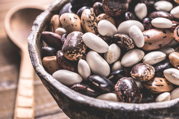 Organic Colorful Beans on Dark Wooden Background