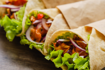 Mexican burrito with chicken, pepper and beans close up