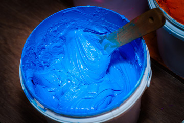 blue color of plastisol ink in white plastic barrel. plastisol ink is specially for print on tee shirts and any fabric plastisol ink is oil type must clean and mix with oil