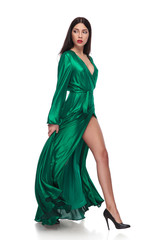 side view of woman in dress walking and looking behind