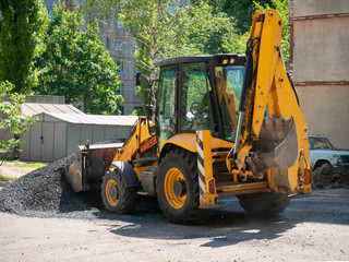 Buldozer Making and constructing a new asphalt road near the civil building. Concepts of improvement of the territory of buildings. Housing and utilities concepts