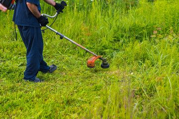 man mowing grass with a lawn mower