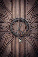 Fototapeta na wymiar Carved door with lock on chain