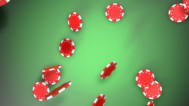 Red poker chips falling down on green play table. 