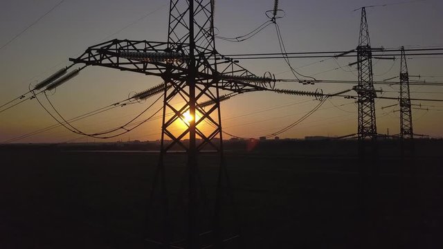 Aerial View of Sunset and High-voltage power pylon. Fuel and power generation. 4K