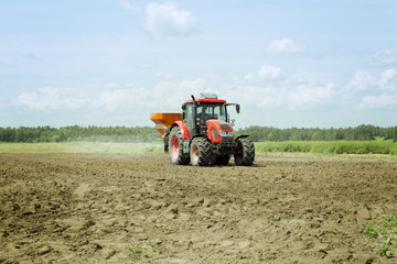 Tractor with sprayer trailer on the cereal field. Heavy machinery for agriculture