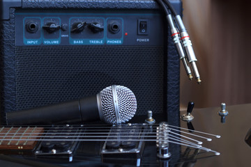 Amplifier, audio cable and microphone near the electric guitar