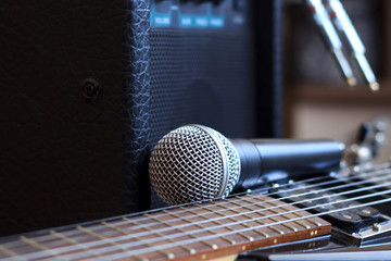 Amplifier, audio cable and microphone near the electric guitar
