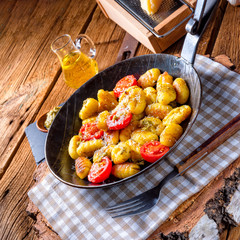 gnocchi baked with green pesto, cherry tomatoes and parmesan