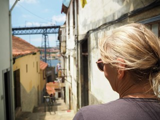 Woman looking down at the streets of porto, Portugal