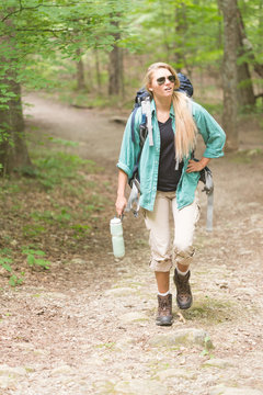 Tired Female Backpacking Hiker Walking On Hiking Trail