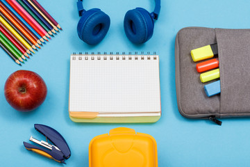 Stapler, apple, color pencils, headphones, notebook, lunch box and bag-pencil case with color felt...