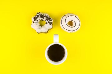 Donut made at home with White Coffee Cup of Espresso on yellow background.Breakfast in the morning rush hour.High energy foods to work.Foods with very high caloriese, sugars and caffeine.
