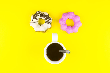 Donut made at home with White Coffee Cup of Espresso on yellow background.Breakfast in the morning rush hour.High energy foods to work.Foods with very high caloriese, sugars and caffeine.