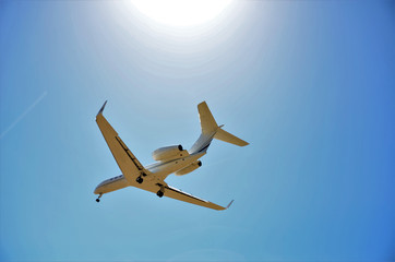 Plane flying over the blue sky. Concept of commercial travel airline