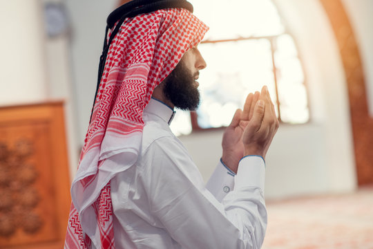 Religious muslim man praying inside the mosque