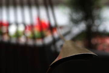 Top of the wooden chair in focus with blurred background of the caffe